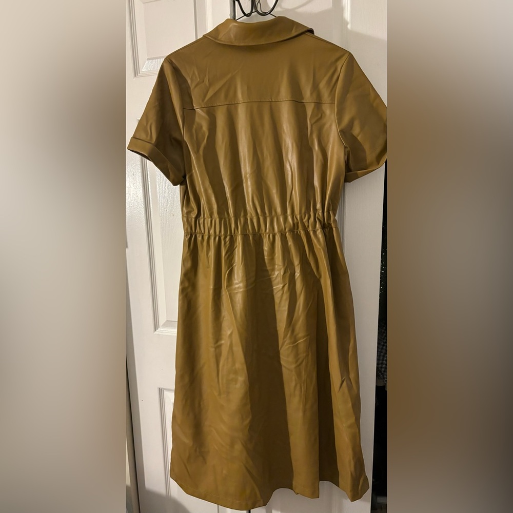 Dress in great condition, has pockets. Faux leather dress; reaches below knees.